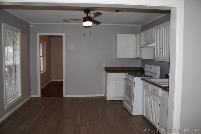 kitchen featuring white appliances, dark countertops, visible vents, and under cabinet range hood