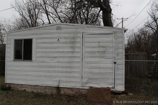 view of shed featuring fence