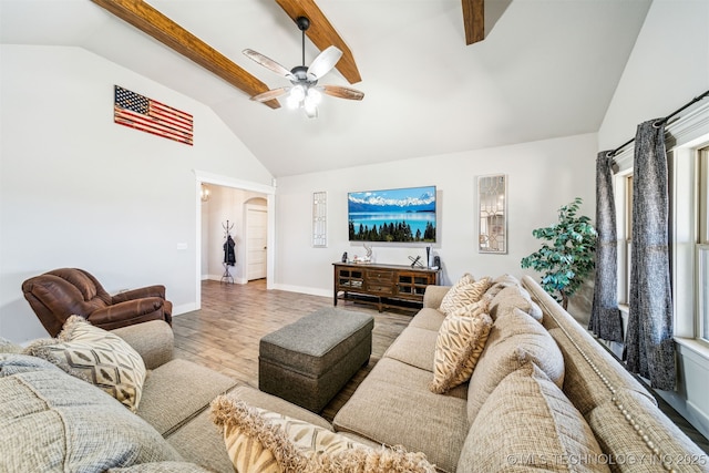 living area featuring baseboards, a ceiling fan, wood finished floors, high vaulted ceiling, and beam ceiling