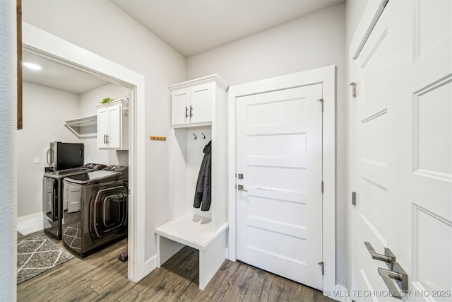 mudroom featuring dark wood-style flooring and washing machine and clothes dryer