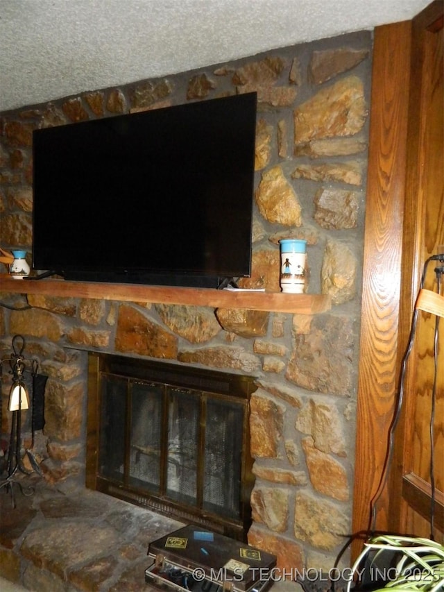 details featuring a textured ceiling and a fireplace