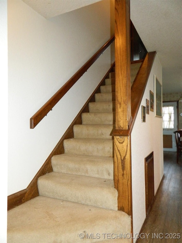 stairs featuring baseboards and wood finished floors
