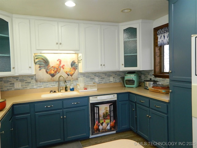 kitchen featuring dishwasher, light countertops, a sink, and glass insert cabinets