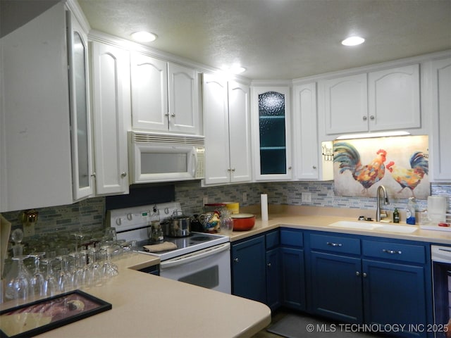 kitchen with white appliances, light countertops, a sink, and blue cabinetry