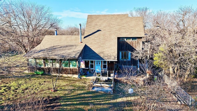 rear view of house featuring a patio area and a lawn