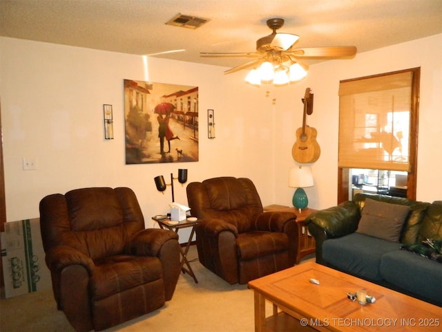carpeted living area featuring visible vents and a ceiling fan