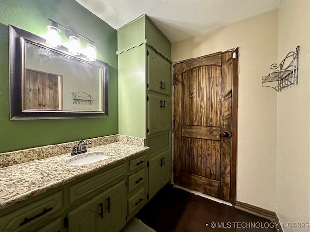 bathroom featuring baseboards and vanity