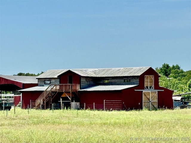 exterior space featuring an outbuilding, metal roof, and a barn