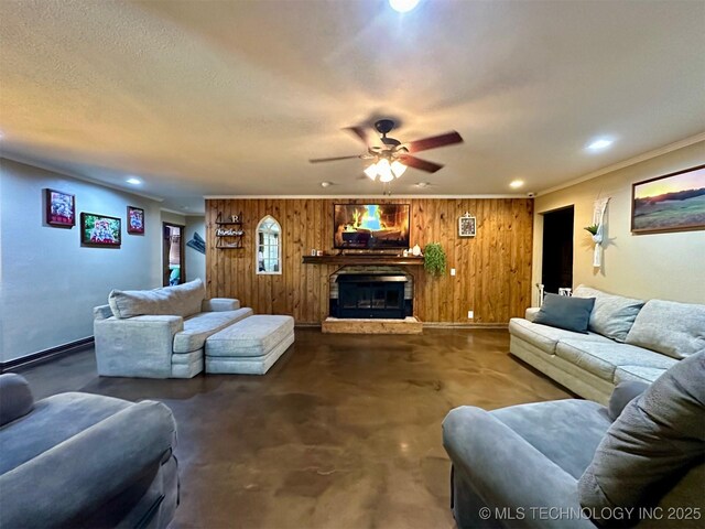 living area featuring a glass covered fireplace, concrete floors, a textured ceiling, and recessed lighting