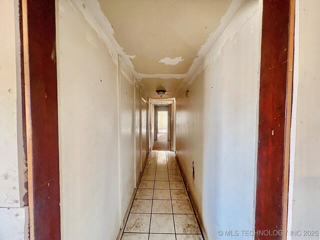 hall with light tile patterned floors