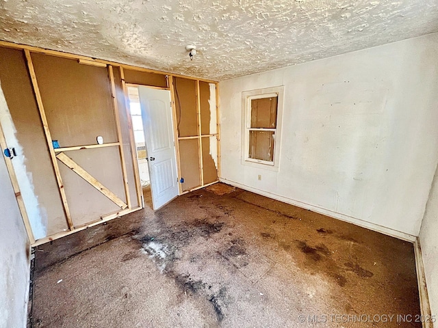 unfurnished bedroom featuring a textured ceiling and a closet