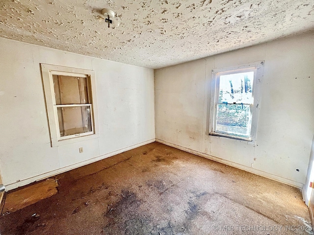 empty room with a textured ceiling