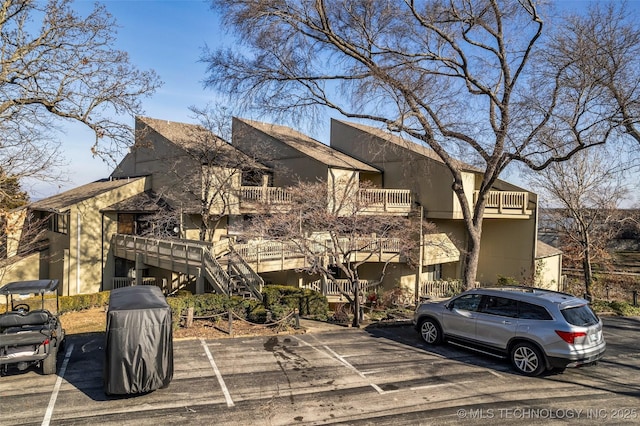 view of building exterior with a residential view and stairway