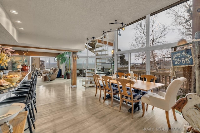 29898 S 566th Rd Unit 411, Afton, OK 74331 - dining room with wood finished floors, a textured ceiling, a wall of windows, and recessed lighting