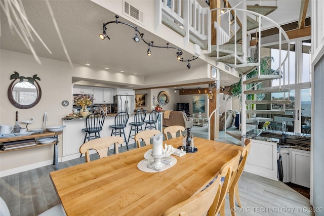 29898 S 566th Rd Unit 411, Afton, OK 74331 - dining area featuring light wood-type flooring, stairs, and baseboards