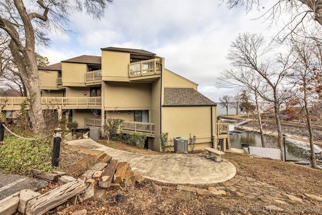 29898 S 566th Rd Unit 411, Afton, OK 74331 - back of property featuring a balcony, central AC unit, and roof with shingles