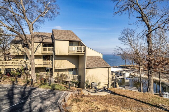 29898 S 566th Rd Unit 411, Afton, OK 74331 - rear view of house with a water view, a balcony, and a shingled roof