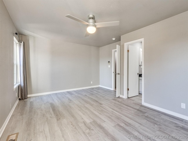 unfurnished room with light wood-type flooring, visible vents, and baseboards