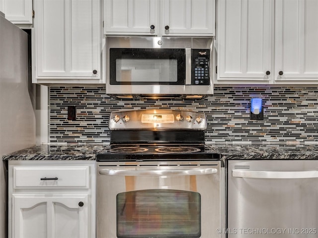 kitchen with white cabinetry, appliances with stainless steel finishes, tasteful backsplash, and dark stone counters