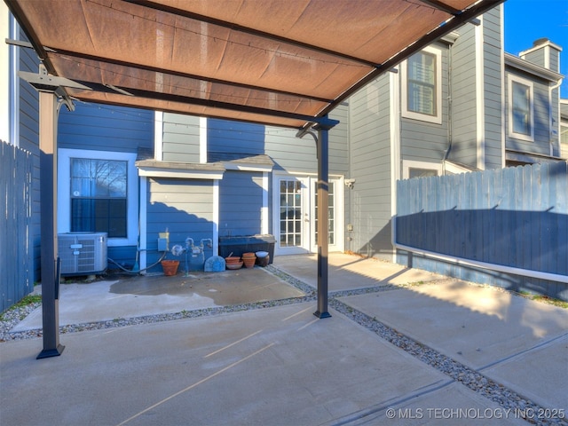 exterior space with fence, cooling unit, and french doors