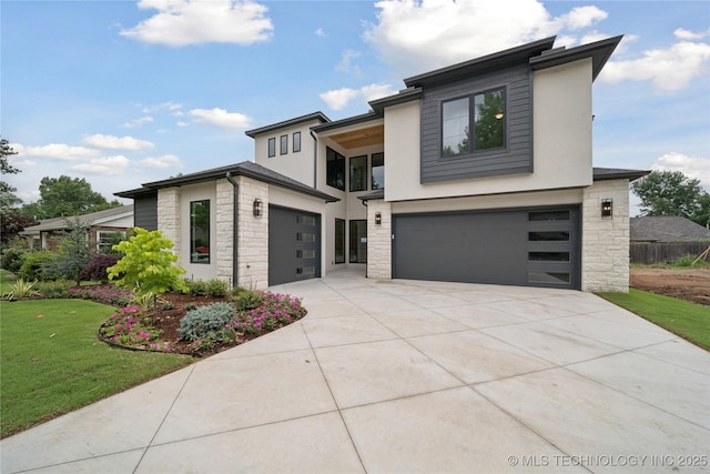 1641 E 32nd St, Tulsa, OK 74105 - contemporary house with stone siding, a garage, driveway, and a front yard