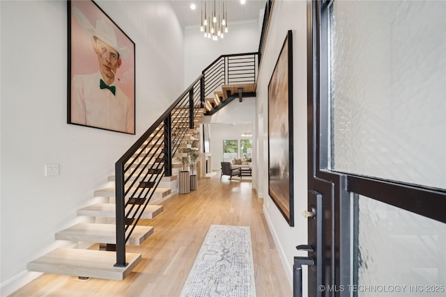 1641 E 32nd St, Tulsa, OK 74105 - entrance foyer with stairs, wood finished floors, a towering ceiling, a chandelier, and crown molding
