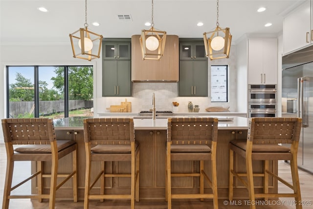 1641 E 32nd St, Tulsa, OK 74105 - kitchen with appliances with stainless steel finishes, light countertops, backsplash, recessed lighting, and pendant lighting