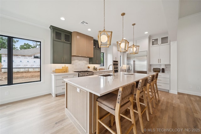 1641 E 32nd St, Tulsa, OK 74105 - kitchen with stainless steel appliances, backsplash, light countertops, light wood-style flooring, and recessed lighting