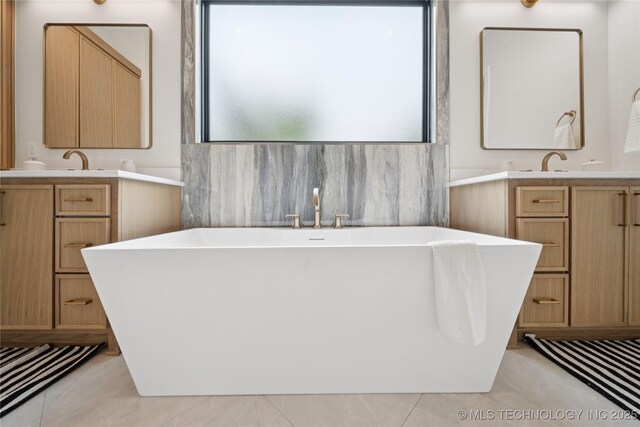 1641 E 32nd St, Tulsa, OK 74105 - bathroom featuring two vanities, a freestanding bath, and tile patterned flooring