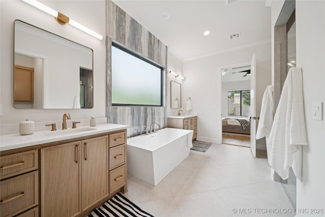 1641 E 32nd St, Tulsa, OK 74105 - full bath with a freestanding tub, two vanities, connected bathroom, crown molding, and tile patterned floors
