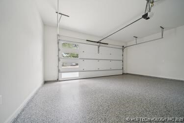 1641 E 32nd St, Tulsa, OK 74105 - garage with a garage door opener and baseboards