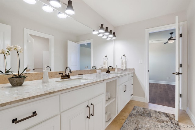 bathroom with a ceiling fan, tile patterned flooring, a sink, and double vanity