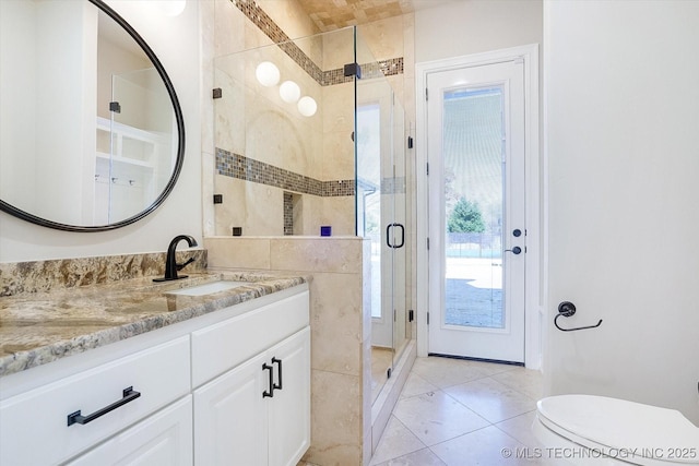 full bath featuring tile patterned flooring, toilet, vanity, tile walls, and a stall shower