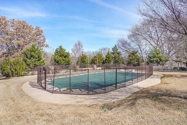 view of swimming pool featuring fence, a fenced in pool, and a yard