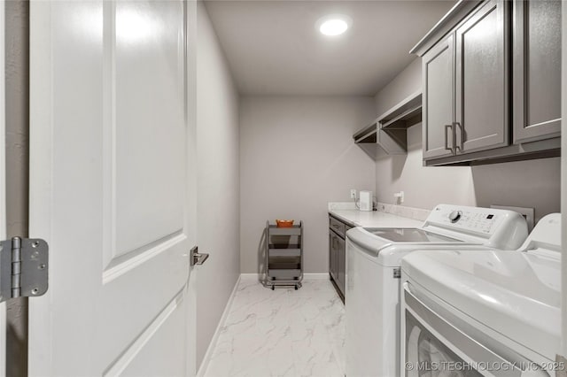 clothes washing area with marble finish floor, baseboards, cabinet space, and independent washer and dryer