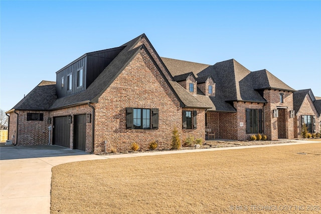 view of front of house featuring driveway, roof with shingles, and brick siding