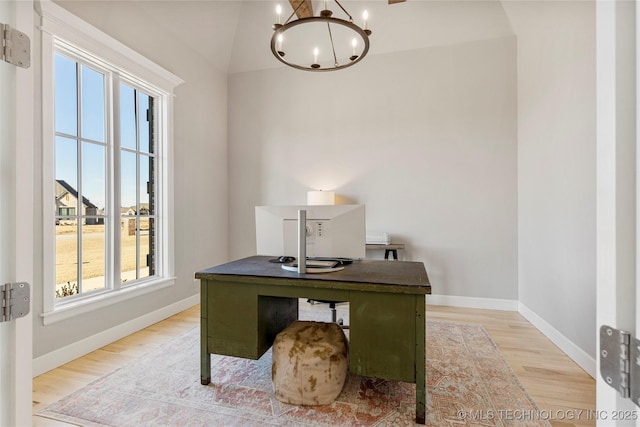 office area with baseboards, light wood-type flooring, and an inviting chandelier