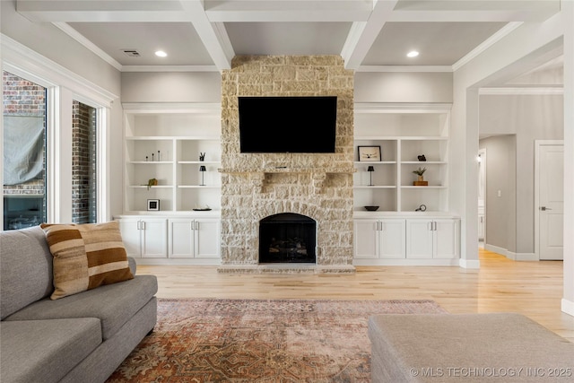 living room featuring a fireplace, coffered ceiling, beam ceiling, and light wood-style floors