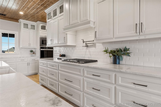 kitchen featuring appliances with stainless steel finishes, wood ceiling, white cabinets, and glass insert cabinets