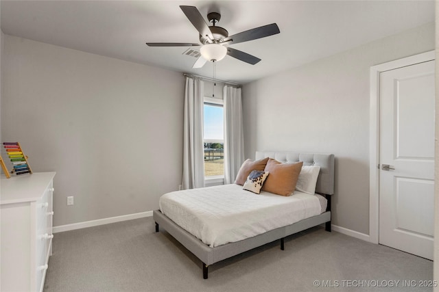 bedroom featuring light carpet, ceiling fan, and baseboards