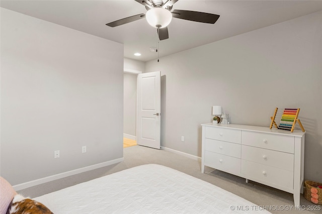 bedroom with light colored carpet, ceiling fan, and baseboards