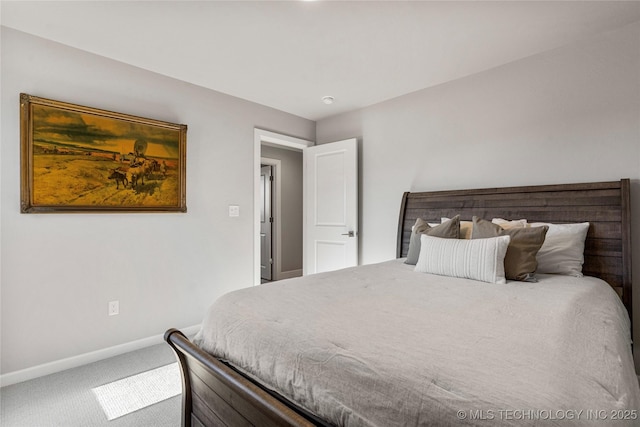 bedroom with carpet flooring and baseboards