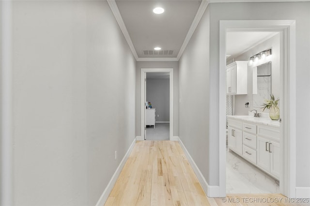 hall with ornamental molding, recessed lighting, visible vents, and baseboards