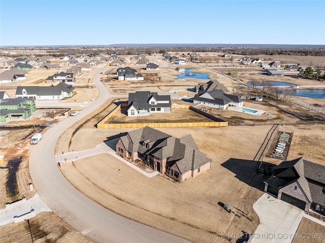 bird's eye view featuring a water view and a residential view