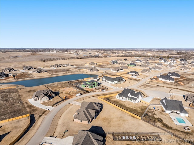 birds eye view of property with a residential view and a water view