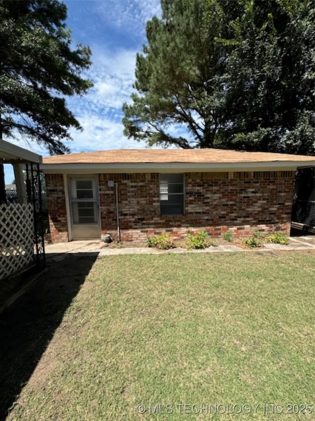 view of front of property with a front yard and brick siding