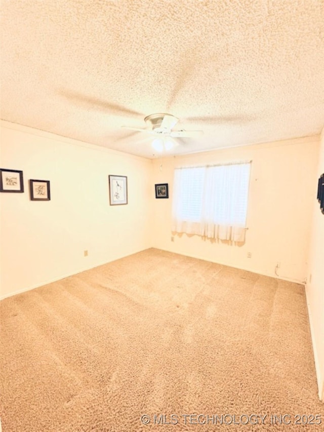 carpeted empty room with a textured ceiling and a ceiling fan