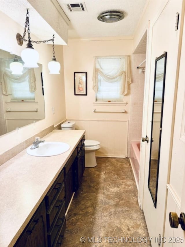 full bath with toilet, a textured ceiling, vanity, and visible vents