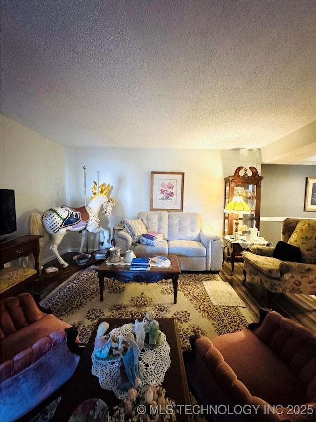 living room with a textured ceiling and wood finished floors