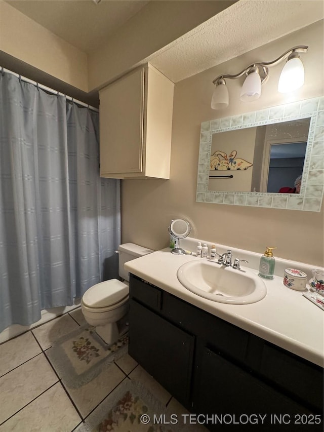 full bath with toilet, tile patterned flooring, a textured ceiling, and vanity